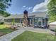 A spacious backyard featuring outdoor seating, lush green grass, and a brick chimney at 116 Hallett St, Fort Mill, SC 29715