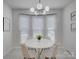 Bright breakfast nook with white table and four chairs, in front of a bay window at 116 Hallett St, Fort Mill, SC 29715