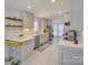 Modern kitchen featuring sleek white cabinetry, stainless steel appliances, and breakfast bar seating at 116 Hallett St, Fort Mill, SC 29715