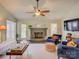 Cozy living room featuring a brick fireplace, ceiling fan, and comfortable seating at 116 Hallett St, Fort Mill, SC 29715