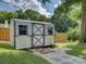 Outdoor shed with a decorative door, windows, and a stone pathway, perfect for storage at 116 Hallett St, Fort Mill, SC 29715