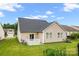 Home's backyard features a patio, lawn, and vinyl siding at 11608 Downy Birch Rd, Charlotte, NC 28227