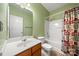 Well-lit bathroom featuring a shower-tub combo, toilet, and wood vanity with mirror at 11608 Downy Birch Rd, Charlotte, NC 28227