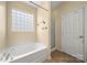 Bathroom features a bathtub and glass block window at 11608 Downy Birch Rd, Charlotte, NC 28227