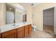 Bathroom featuring double sinks, a large mirror, and tile floors at 11608 Downy Birch Rd, Charlotte, NC 28227