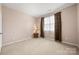 Bedroom with neutral walls, carpet, window with curtains and lamp on small table at 11608 Downy Birch Rd, Charlotte, NC 28227