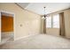 Spacious dining room with neutral carpet and natural light from large windows at 11608 Downy Birch Rd, Charlotte, NC 28227