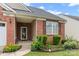 Inviting front porch with decorative plants framing the entry and side window at 11608 Downy Birch Rd, Charlotte, NC 28227