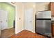 Cozy eat-in kitchen with stainless steel refrigerator, vinyl flooring and a laundry room nearby at 11608 Downy Birch Rd, Charlotte, NC 28227