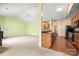 Open-plan kitchen leading to living room with wood cabinets, and stainless steel appliances at 11608 Downy Birch Rd, Charlotte, NC 28227
