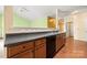 Kitchen featuring wood cabinets, laminate countertop and stainless steel appliances with a view to the living room at 11608 Downy Birch Rd, Charlotte, NC 28227
