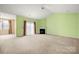 Spacious carpeted living room with fireplace, ceiling fan and sliding glass door at 11608 Downy Birch Rd, Charlotte, NC 28227