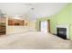 Open living room with a fireplace, ceiling fan and sliding glass door next to the kitchen at 11608 Downy Birch Rd, Charlotte, NC 28227