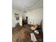 Living room view of hardwood floors, with a fireplace and view into an adjacent room at 118 Hemphill Ave, Chester, SC 29706