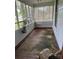 An enclosed front porch area featuring wood trim with a concrete floor and natural light at 118 Hemphill Ave, Chester, SC 29706
