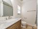 Elegant bathroom featuring a marble countertop, vanity, mirror, and shower-tub combination at 12131 Honor Guard Ave, Charlotte, NC 28277