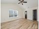 Spacious bedroom with large window, ceiling fan, vaulted ceiling, and ensuite bathroom access at 12131 Honor Guard Ave, Charlotte, NC 28277