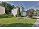 Charming two-story home with manicured lawn, mature trees, and beautiful landscaping at 12131 Honor Guard Ave, Charlotte, NC 28277
