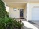 Inviting front porch featuring a decorative door wreath, well-manicured landscaping, and stylish exterior details at 12131 Honor Guard Ave, Charlotte, NC 28277