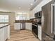 Bright, open kitchen with stainless steel appliances and granite countertops at 12131 Honor Guard Ave, Charlotte, NC 28277
