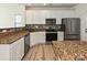 Well-lit kitchen with stainless steel appliances and granite countertops at 12131 Honor Guard Ave, Charlotte, NC 28277