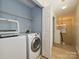 Convenient laundry room with modern washer and dryer, plus shelving for ample storage at 12131 Honor Guard Ave, Charlotte, NC 28277