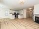 Open-concept living space with a modern kitchen featuring stainless steel appliances, granite counters, and a cozy living room at 12131 Honor Guard Ave, Charlotte, NC 28277