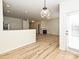 Open living space with wood floors, leading to a living room with fireplace, dining area, and backyard access at 12131 Honor Guard Ave, Charlotte, NC 28277