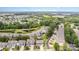 Expansive aerial view of the community, displaying lush greenery, a pond, and well-spaced homes in a serene setting at 126 W Morehouse Ave, Mooresville, NC 28117