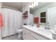 Well-lit bathroom featuring double sinks, decorative mirror, and ample counter space at 126 W Morehouse Ave, Mooresville, NC 28117