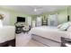 Bedroom with a light green wall, a ceiling fan, a TV, and a full bed at 126 W Morehouse Ave, Mooresville, NC 28117