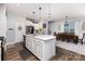 Open kitchen and dining area featuring an island, stainless steel appliances, and a dining table at 126 W Morehouse Ave, Mooresville, NC 28117