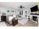 Cozy living room with a fireplace, plush seating, and wood-style flooring at 126 W Morehouse Ave, Mooresville, NC 28117