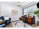 Inviting home office with a wooden desk, comfortable chair, ample natural light, and a decorative world map at 126 W Morehouse Ave, Mooresville, NC 28117