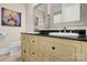 Bathroom featuring double vanity with black countertops, decorative mirror, and tiled floors at 141 Castle Dr, Mooresville, NC 28117