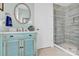 Bathroom with vanity, framed mirror, step-in shower, and neutral tile accents at 141 Castle Dr, Mooresville, NC 28117