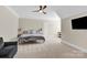 Spacious bedroom featuring a ceiling fan, neutral tones, and soft carpet flooring at 141 Castle Dr, Mooresville, NC 28117