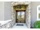 Elegant front door with decorative glass and stone surround, creating a grand entrance at 141 Castle Dr, Mooresville, NC 28117