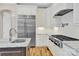 Modern kitchen featuring white cabinets, stainless steel appliances, and hardwood floors at 141 Castle Dr, Mooresville, NC 28117