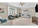 Comfortable living room with plush seating, a ceiling fan, and ample natural light from the large window at 141 Castle Dr, Mooresville, NC 28117