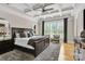 Serene main bedroom featuring a tray ceiling, plush carpet, and plenty of natural light at 141 Castle Dr, Mooresville, NC 28117