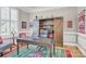 Charming home office featuring custom shelving, a unique rug, and ample natural light at 141 Castle Dr, Mooresville, NC 28117
