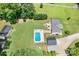 This aerial view showcases the pool, outbuildings, deck, and expansive property at 1489 L R Schronce Ln, Iron Station, NC 28080