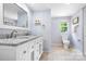 Bright bathroom featuring a double sink vanity, granite countertops, and tile floors at 1489 L R Schronce Ln, Iron Station, NC 28080
