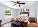 Bright bedroom showcasing a bed, side table, and window offering natural light at 1489 L R Schronce Ln, Iron Station, NC 28080