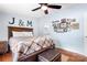 Comfortable bedroom featuring a wooden bed, hardwood floors, and decorative Gathering wall art at 1489 L R Schronce Ln, Iron Station, NC 28080