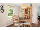 Charming dining area with warm lighting, hardwood floors, and a display cabinet, perfect for Gathering meals at 1489 L R Schronce Ln, Iron Station, NC 28080