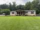 Charming single-story home featuring a cozy front porch and a well-maintained lawn at 1489 L R Schronce Ln, Iron Station, NC 28080