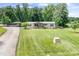 Charming ranch home featuring a covered porch, a well-manicured lawn and carport at 1489 L R Schronce Ln, Iron Station, NC 28080