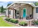 Inviting front porch with rocking chairs and manicured landscaping, perfect for enjoying peaceful moments outdoors at 1489 L R Schronce Ln, Iron Station, NC 28080